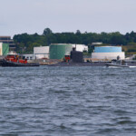Submarine moving up river under escort